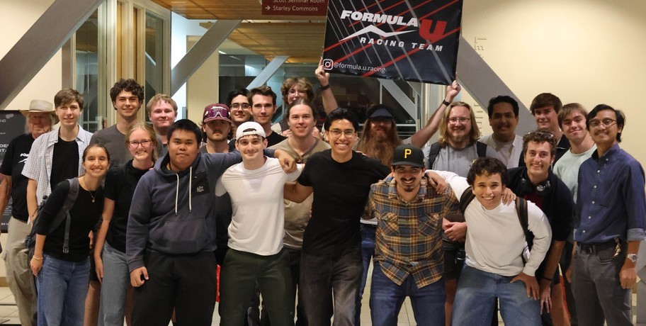 Formula U Racing students gathered under the team banner